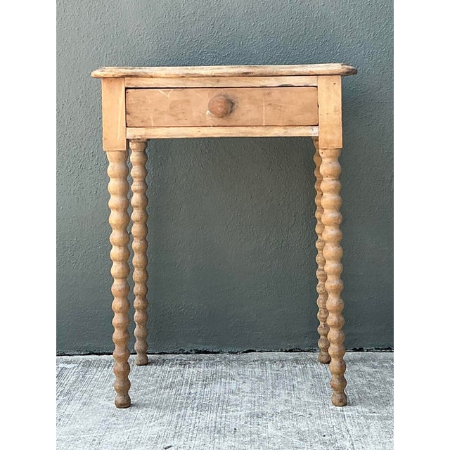 This exquisite antique primitive side table is a soulful testament to turn-of-the-century craftsmanship, blending rustic...