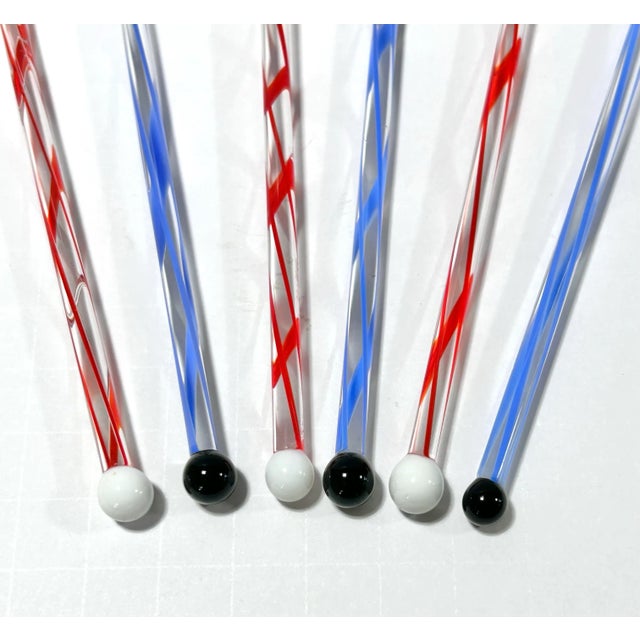 A whimsical set of six 1990s hand-blown glass cocktail swizzle sticks, each topped with a colorful lampworked rooster or...