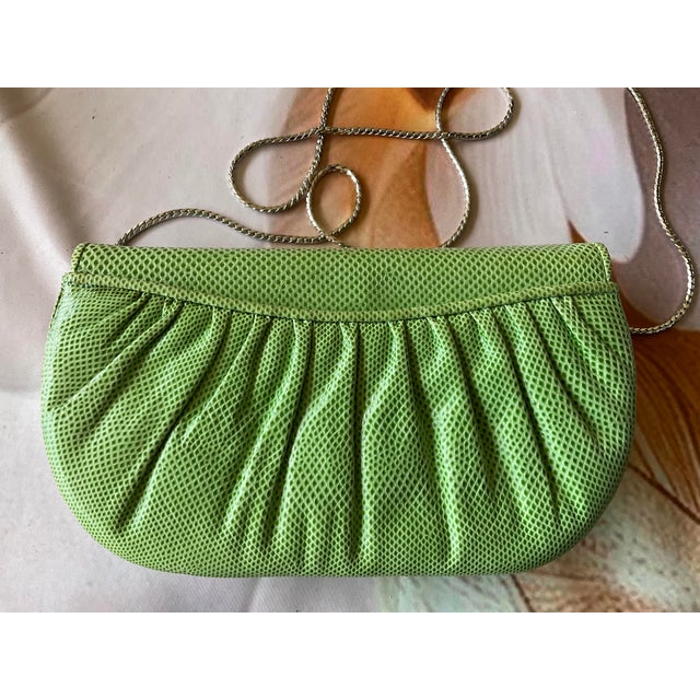 Judith Lieber light green lizard clutch with pleated detailing, silver-tone marcasite-accented clasp, and 19-inch drop...