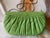 Judith Lieber light green lizard clutch with pleated detailing, silver-tone marcasite-accented clasp, and 19-inch drop...