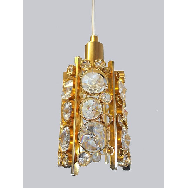 Elegant petite gilt brass chandelier with faceted swarovski crystals. Manufactured by palwa, germany in the 1960s....