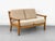 High-quality two-seater sofa made of solid oak. Spring core cushions upholstered in a textured beige fabric. •...