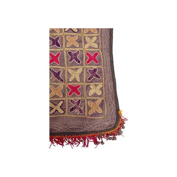 Embroidered fragment of a vintage textile with fringe and metal sequins from the Grand Bazaar in Istanbul.