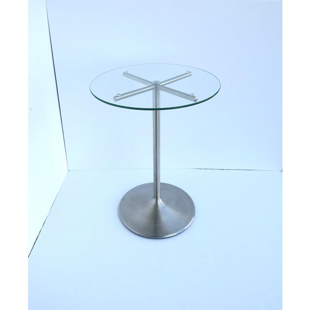 A brushed metal and glass side or drinks table, Modern Minimalist design styles, circa late-20th century. A brushed‑metal...