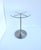 A brushed metal and glass side or drinks table, Modern Minimalist design styles, circa late-20th century. A brushed‑metal...