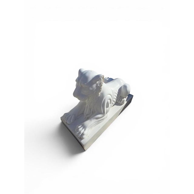 Elegant pair of lion sculptures carved from fine white marble in Italy during the second half of the 20th century....