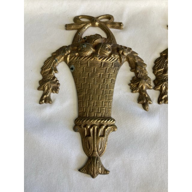 This set of two vintage solid brass basket wall decorations brings classic style and warmth to any interior. Crafted from...