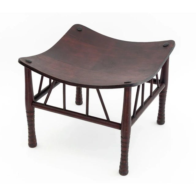Liberty & Co. Attributed "Thebes" Oak Stool, with bentwood seat on four turned wood supports conjoined by a box stretcher....