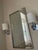 A handsome pair of modern sconces in gleaming polished chrome, with a clean circular backplate and a squared,...