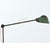 A French industrial floor lamp with a cast iron base and adjustable steel arms. From top to bottom, the surface of the...