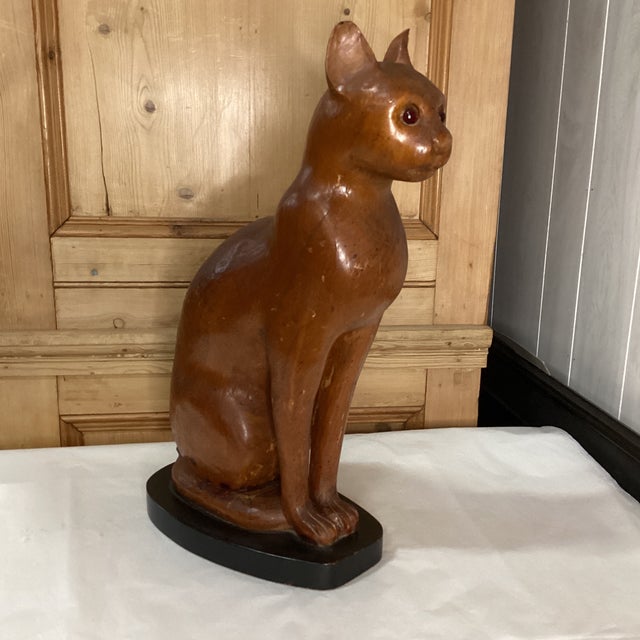A handsomely hand carved solid wood cat sculpture from Italy. This mid 20th century sculpture from Italy has a rich patina...