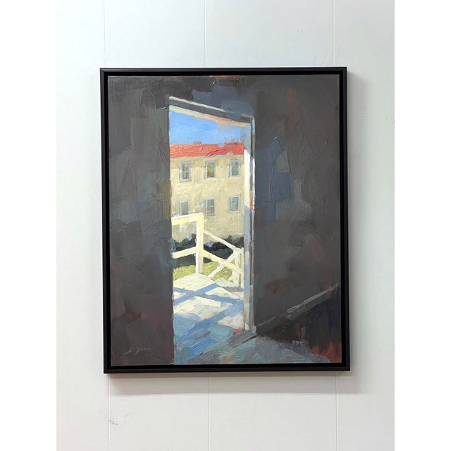 In "Doorway," light spills through an open door, illuminating a serene outdoor scene that contrasts with the darker...