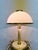 One Italian table lamp from the 1970s/80s, two-light, E27 socket. Brass, cream-white lacquered metal, Murano glass. Good...