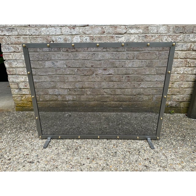 Handcrafted fireplace screens made out of iron, brass knots, and brass or steel mesh.