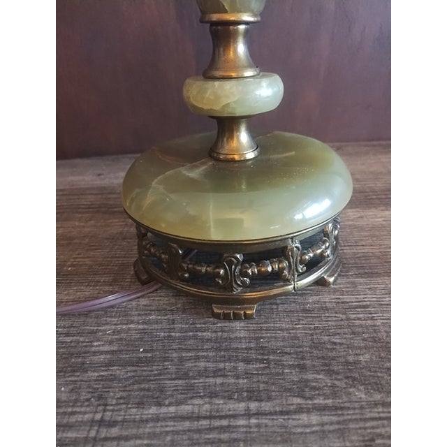 Gorgeous heavy table lamp made of onyx or marble and brass. Gently used with no flaws. Works well.