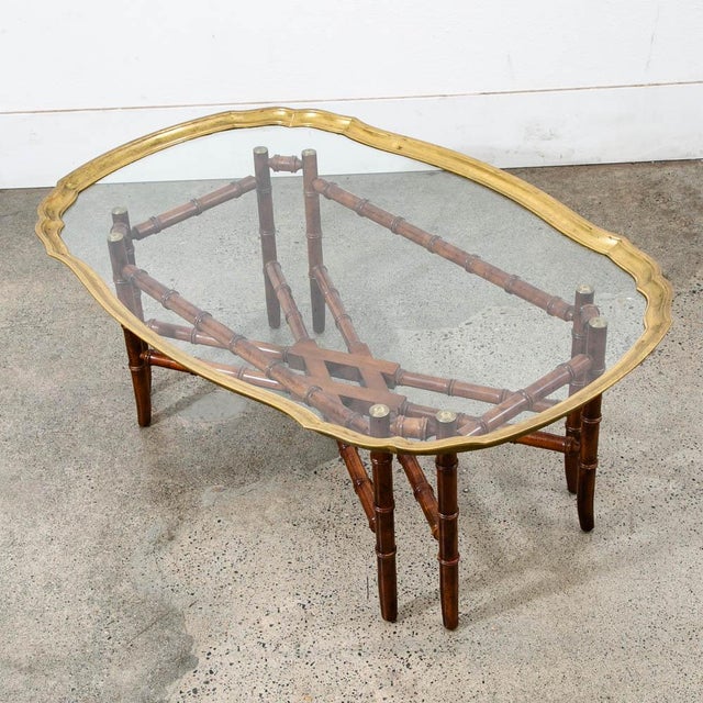 Unique Brass, glass and wood cocktail / coffee table with glass top surface. Brass trim throughout. unique and well made....