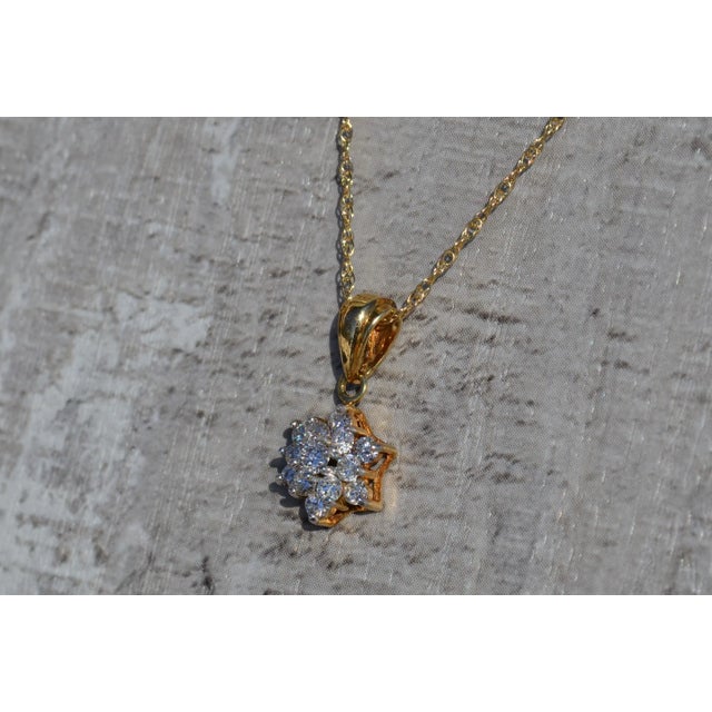 The Siobhan Ladies Diamond Star Cluster Necklace in 14K. Dangling from am 18 inch yellow gold chain is a 3/8 inch star...