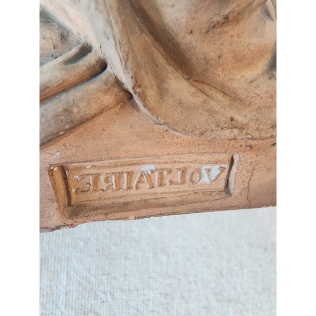 Terra cotta bust sculpture of Voltaire. Note name is printed backwards on bust.