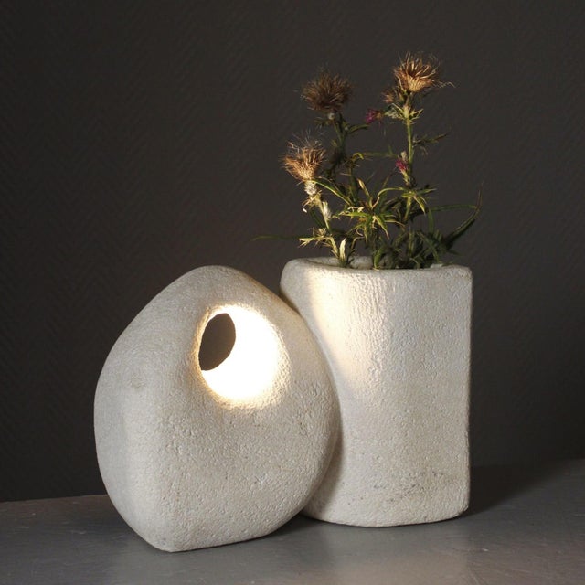 A beautiful decorative lamp, half of which serves as a vase, made of hand-carved Pierre du Gard stone, unsigned but...