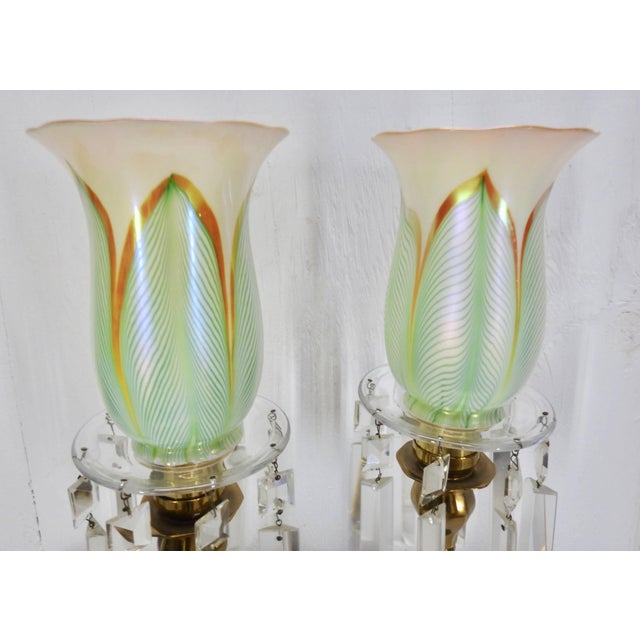 We are offering an exquisite pair of antique brass lamps with Steuben “Pulled Feather” pattern glass shades. The lamps...