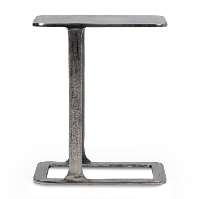 Modern cast aluminum end table with a cool antiqued nickel finish. Its sculptural cantilever silhouette offers a refined...