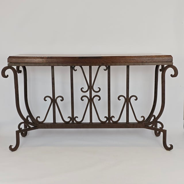 Beautiful handcrafted Spanish style console table with a mesquite wood top and a unique iron base. The tabletop is simply...