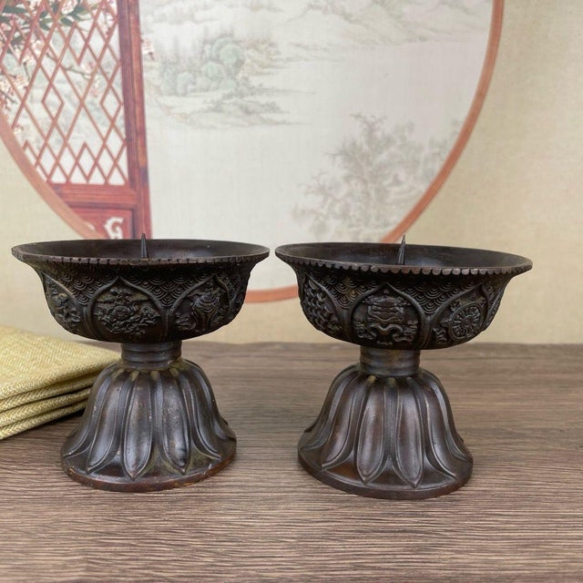 This elegant pair of bronze candlesticks features a classic lotus design, a traditional symbol of purity and...
