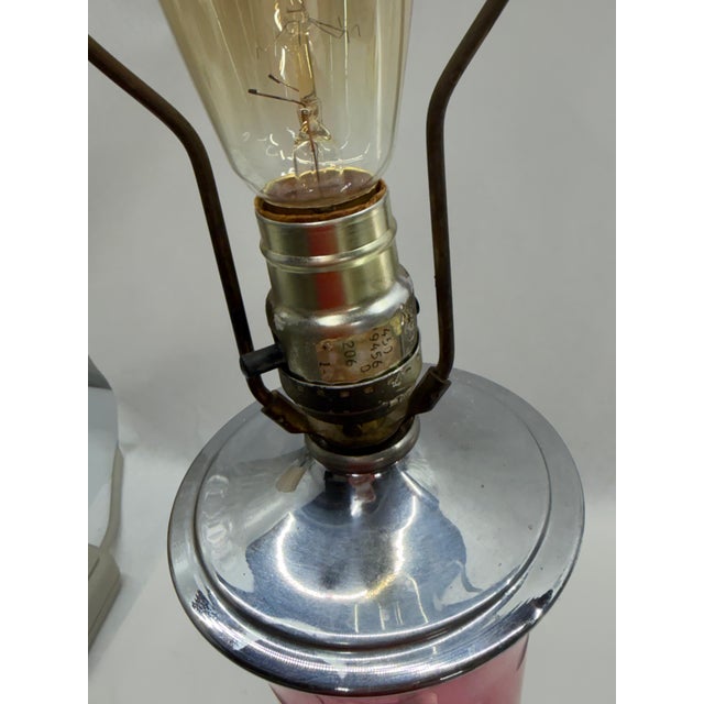 Vintage Bohemian-style table lamp featuring a flared trumpet body in vibrant cranberry/ruby glass with delicate wheel-cut...