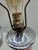 Vintage Bohemian-style table lamp featuring a flared trumpet body in vibrant cranberry/ruby glass with delicate wheel-cut...