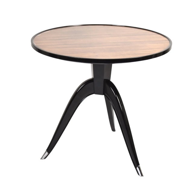 Bold and striking round tripod center or side table. Features ebonized wood with a round center inset of macassar. Three...