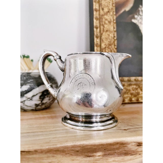 This is a petite antique circa 1910-1920s heavy silver plated creamer from the Hotel Tyrol in Innsbruck, the Swiss alps....