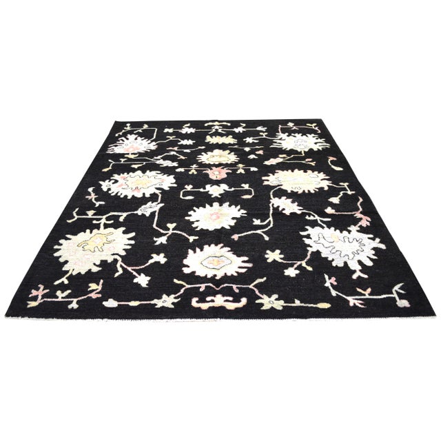 Oushak hand knotted wool rug with natural colors, floral style, and fine weave.
