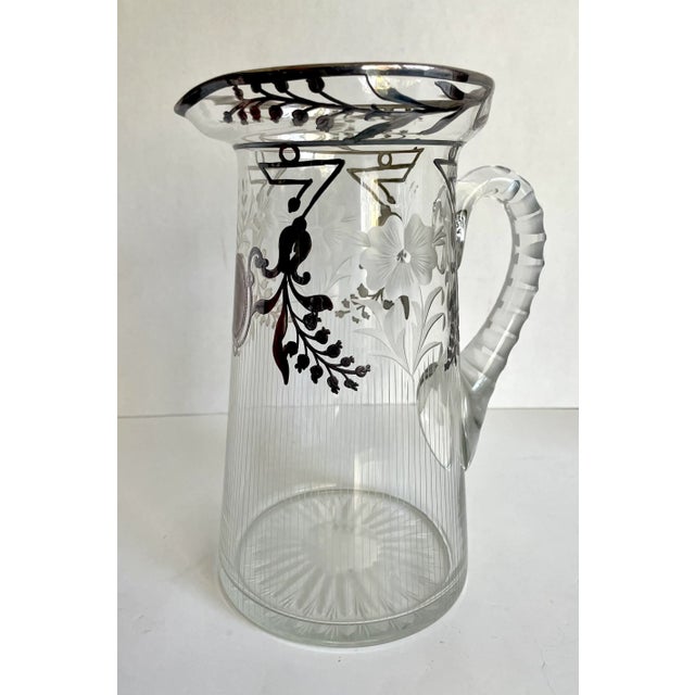 Here is a stunning cut glass pitcher featuring inlay sterling silver and etched floral designs. Pitcher is from Art Deco...