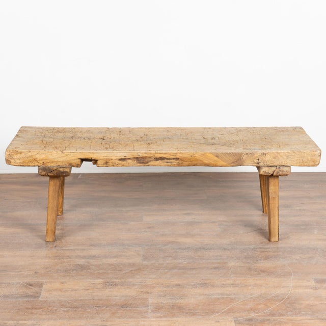 The appeal of this rustic coffee table comes from the thick wood of the top that originally served as a worktable, all...