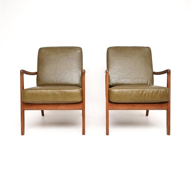 A stylish and extremely well made pair of Danish vintage teak and leather armchairs by Ole Wanscher. They are model FD109...