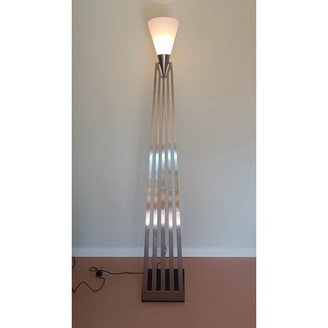 Stately floor lamp in Art Deco style made by IDL Lighting Italy. The lamp has a cast iron base, a stainless-steel metal...