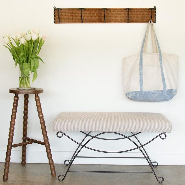 Beautiful iron bench with curved and looped base painted in a matte black finish inspired by French design. Rectangular...