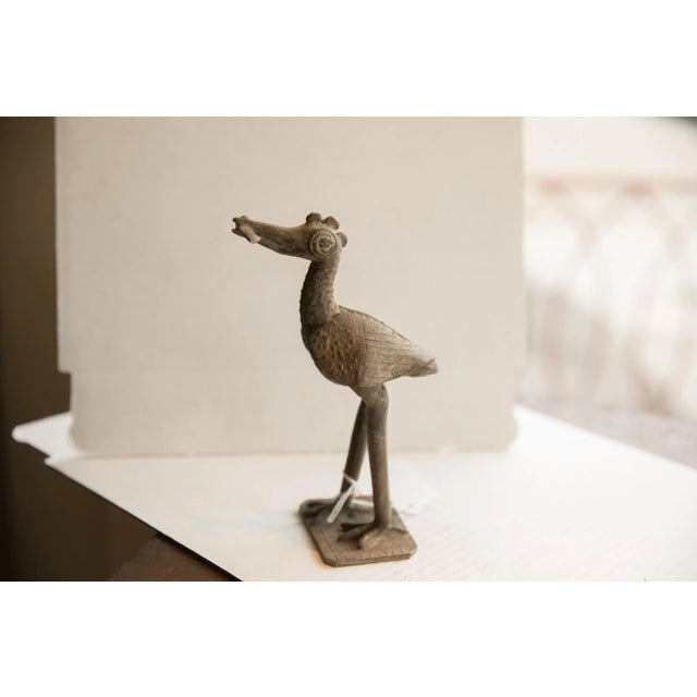 :: Vintage handmade African bird with fish sculpture. Circa late mid 20th century, though possibly older, this piece has...