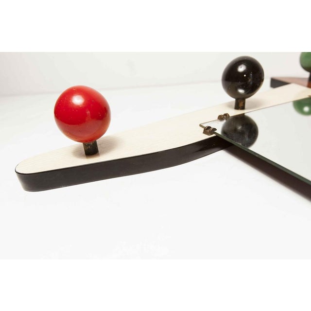 Asymmetrical wall worker with mirror and atypical of the 70s. The frame is in formica two tones, beige and brown. Forty...