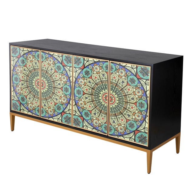 The Solani Sideboard is defined by its rich, dark foundation, elevated by a refined base in a warm gold finish. Four doors...