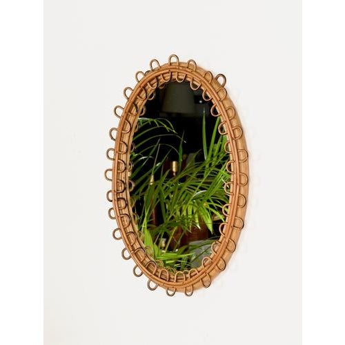 Wonderful Mid-Century French Riviera style oval mirror entirely crafted in curved rattan and bamboo. The design of this...