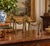 A distinctive pair of vintage West African style lost-wax brass elephant sculptures, each rendered with an elongated...