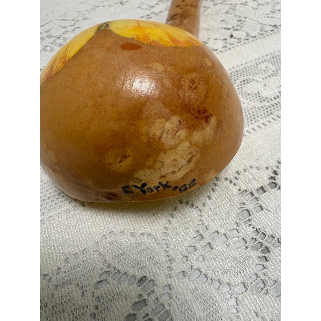 Vintage handmade rustic whimsical ladle carved from a gourd and hand painted with a yellow butterfly and a suede loop tie....