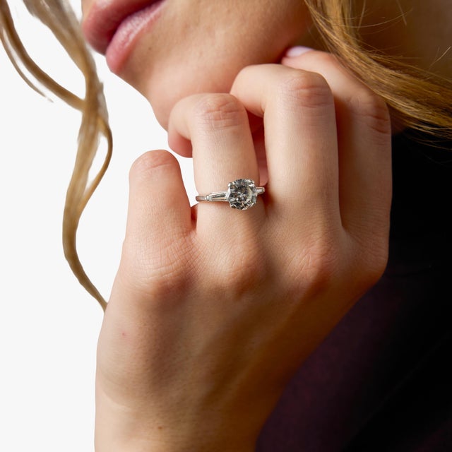 This elegant Mid Century engagement ring centers on a stunning 1.95 carat round brilliant cut diamond, certified by GIA...