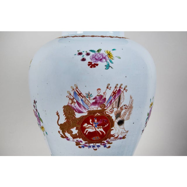 Two, hand-painted, Republic period, parcel-gilt, lidded urns made for the U.K. market. Both pieces feature a central...