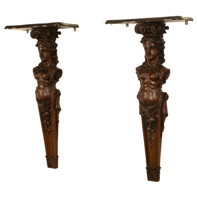 An exceptional large pair of 19th century Italian carved walnut Renaissance Revival statue wall brackets, circa 1850. This...