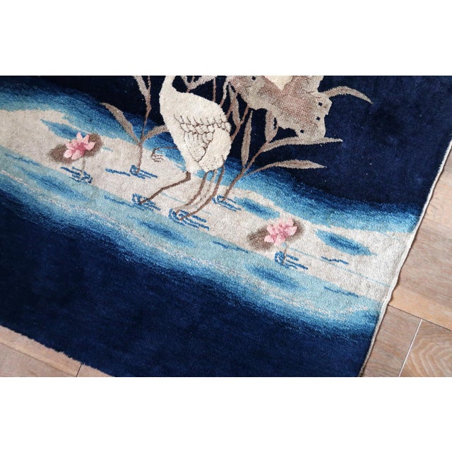 This handmade antique Chinese Peking rug from the 1890s presents a refined and poetic composition rooted in traditional...