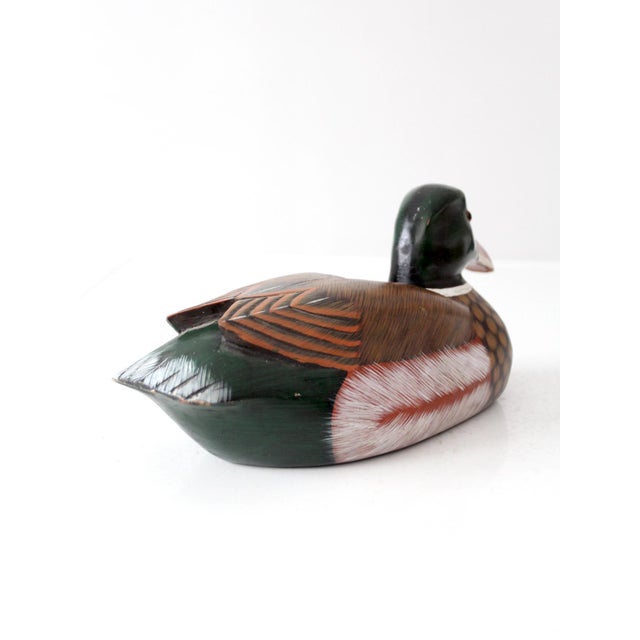 Vintage carved wood mallard decoy with richly hand-painted plumage, carved wing detailing, and inset amber eyes. The...