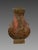 Bronze vase with a red patina, Early Han Dynasty (206 BC - 220 AD). The vase is decorated with Taotie masks ending in...