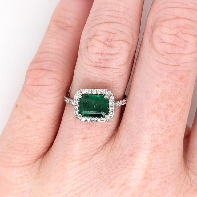This classic NNJ ring design features a 1.21 carat east west emerald gemstone with natural earth-mined diamonds all set in...